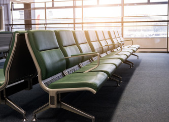 Row of empty chairs  in the airport at the morning