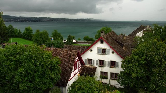 Iconic view of swiss train passing Richterswil village on lake Zurich Zürichsee in Switzerland
