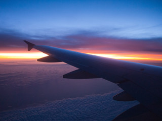 Fototapeta na wymiar Airplane wing sunset over ocean