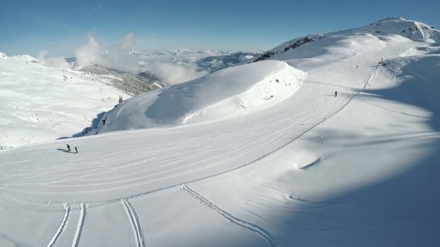 People skiing on the prepared slope with fresh new powder snow in Tyrolian Alps, Zillertal, Austria 
