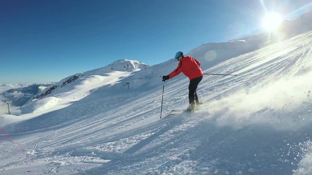 Man skiing on the prepared slope with fresh new powder snow in Tyrolian Alps, Zillertal, Austria 
