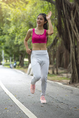 Girl is jogging in the morning in the park.