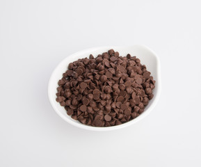 Chocolate chip morsels spread on a background.