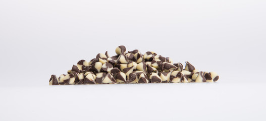 Chocolate chip morsels spread on a background.