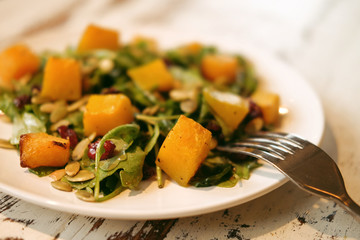 salad with pumpkin, pumpkin seeds and arugula