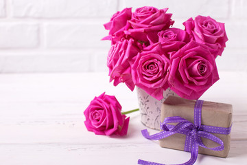 Bright pink roses flowers in pot  and box with present