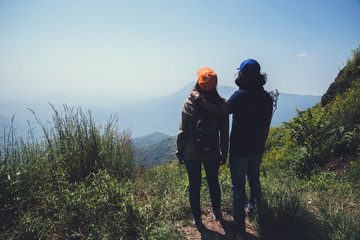 Lover women and men asians travel relax in the holiday. Stand up landscape on the Moutain. Mountain Park happily. In Thailand