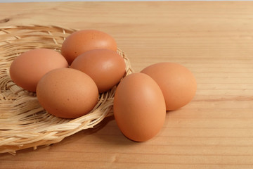 Eggs in the basket on Wooden floor
