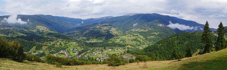 Fototapeta na wymiar Carpatian mountains village at green forest panorama