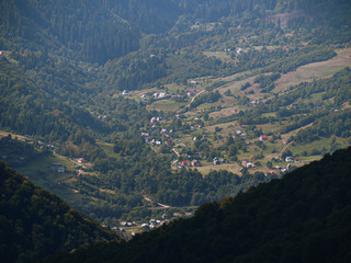 Fototapeta premium Carpatian mountains village at green forest