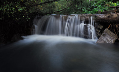 Waterfall at the carpatian mountains green forest