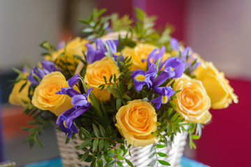 Part of a bouquet of yellow roses in a basket close-up