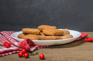 Biscuits, milk, red napkin, Christmas decor with free space for text.