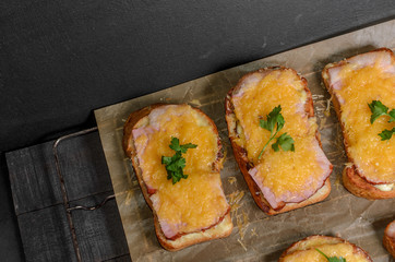 Six sandwiches with meat, cheese and greens top view