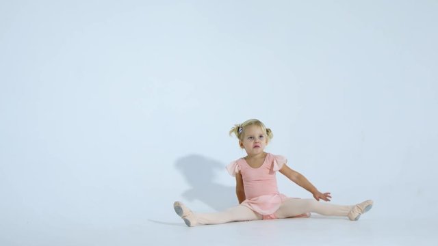 A small ballerina dances with enthusiasm. The girl is engaged in ballet