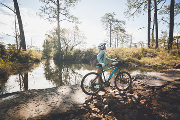 Fototapeta premium Mountain Bike cyclist riding single track at sunrise healthy lifestyle active athlete doing sport