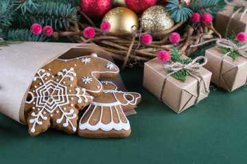 Homemade christmas cookies with decor on  green  background.