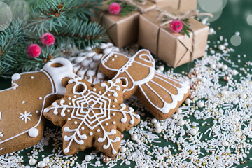 Christmas and holiday baking . Ginger cookies with decor on  green  background.
