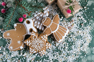 Homemade christmas cookies with decor on  green  background.