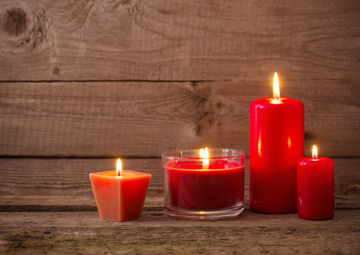 red candles on dark wooden background