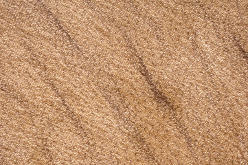 Fototapeta na wymiar Texture light beige soft dense fabric with abstract brown chaotic stripes