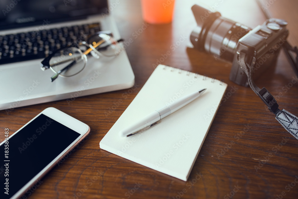 Poster office table with blank notebook and laptop