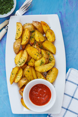 Baked potato slices with herbs in a white dish