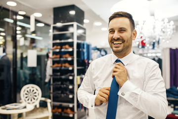 Smiling Young Man Buying a Shirt
