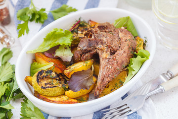 Grilled lamb with baked vegetables.
