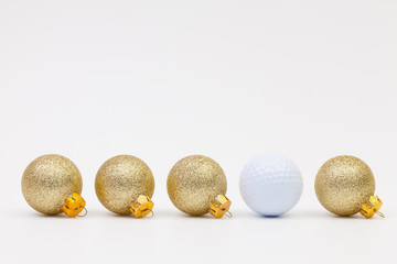 Gold Christmas decoration and white golf ball