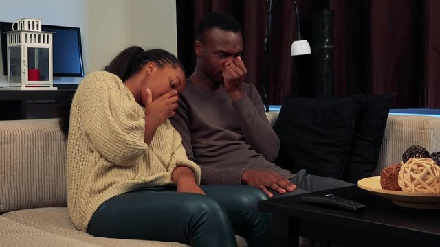 Young black unhappy couple are crying and have depression in living room 