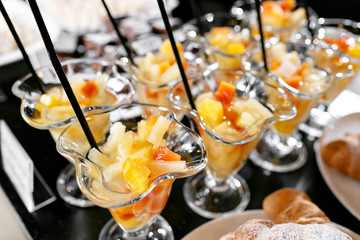 Dessert with pieces of fruit. Morning hotel breakfast buffet. Dessert fruit cocktail in cups