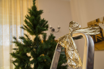 close up Christmas bow on the ladder with Christmas tree.jpg