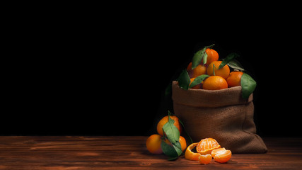 Obraz na płótnie Canvas New Year's tangerines on a wooden rustic background