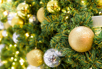 Closeup of Christmas tree hanging with decorated items.