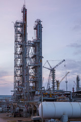 Fototapeta na wymiar construction of distillation column on sunset