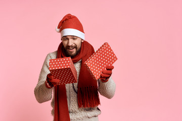 a man holds an open box in his hands, a light pink background, free space for copying, a new year