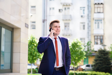 Successful businessman talking on the phone and smiling.