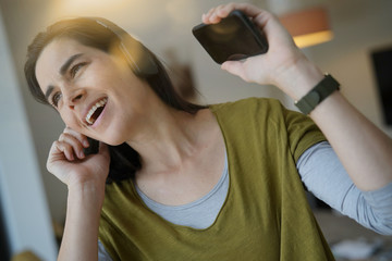 Woman listening to music with bluetooth headset