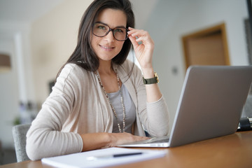 Portrait of smiling middle-aged active woman working from home