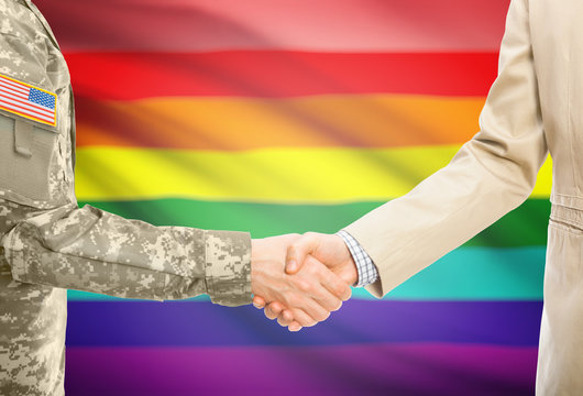 USA military man in uniform and civil man in suit shaking hands with adequate national flag on background - LGBT