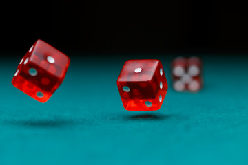 Picture of dice falling on green table