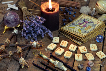 Fototapeta na wymiar Tarot cards, ancient runes, black candle and pentagram. Occult, esoteric, divination and wicca concept. Mystic and vintage background