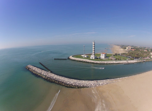 Aerial view of lighthouse, beach, sea, river, boat, italy jesolo
