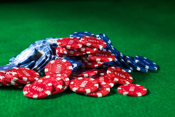 Poker chips on a green background in the casino.