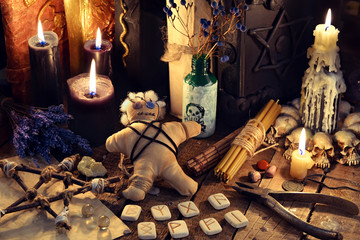 Voodoo doll, black candles, pentagram and old books on witch table. Occult, esoteric, divination and wicca concept. Mystic, voodoo and vintage background - obrazy, fototapety, plakaty