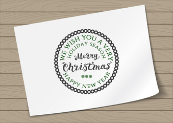 Round in Frame Badge Merry Christmas and Happy New Year with Hand Drawn Lettering and Snowflake Icon on A4 Sheet Paper on Wooden Background. Green Logo Emblem Vector Illustration.
