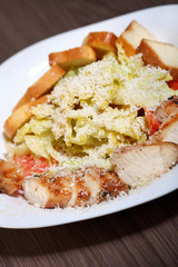 Grilled chicken fillets on slate plate.Wooden concrete background