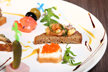 Canapes with salmon red caviar on a wooden background.Toast