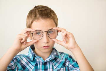 Handsome teen boy wears glasses. Poor vision and medicine concept